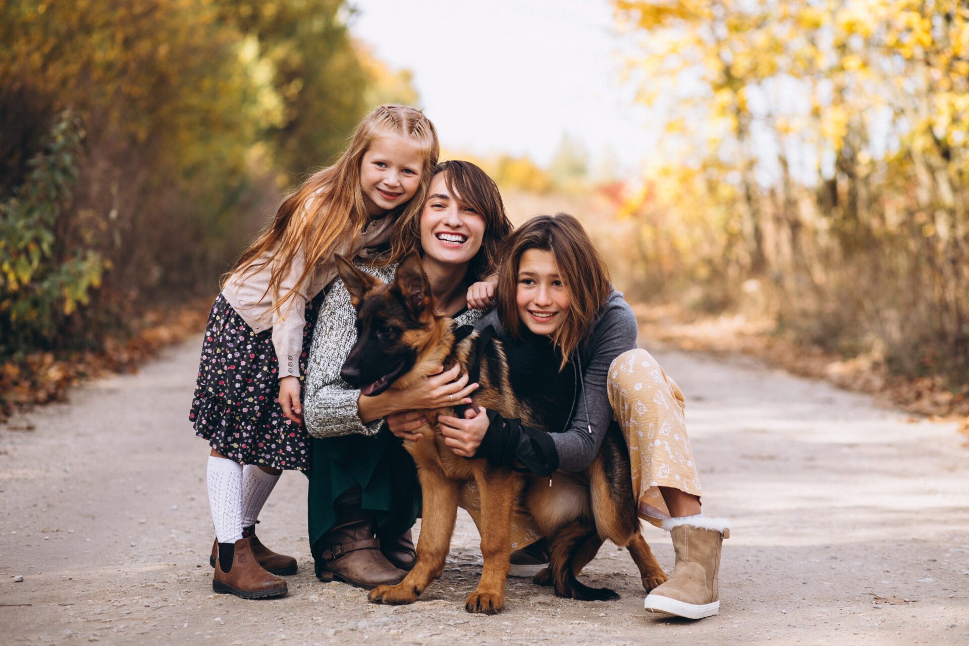 Mother with kids and dog in an autumn park